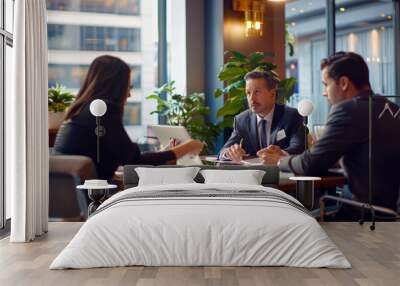 A financial advisor meets with clients in a bright, modern office against a backdrop of investment charts and tables, discussing finance, mortgages and investment strategies. Reflects personal financi Wall mural