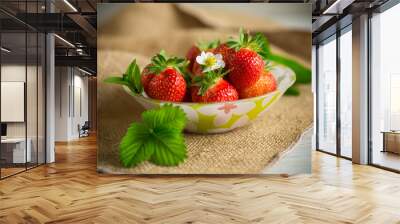 ripe red strawberries in a bowl on a burlap tablecloth Wall mural