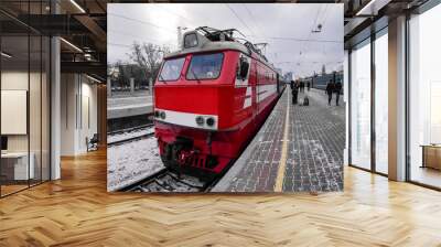 red locomotive on train station platform in the winter Wall mural