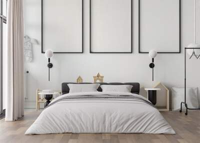 A minimalist nursery interior design with a white floor and white walls. featuring three black picture frames. two round rugs. and a variety of wooden toys Wall mural