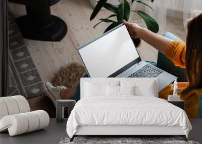 young woman using laptop to work home, remote work Wall mural