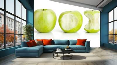 One whole and two bited green apples fruit on white Wall mural