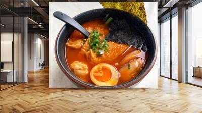 Japanese Korean ramen noodle in red tomato spicy chilli hot soup with onsen egg, seaweed, pork belly, bean curd, dumpling in bowl on white table asian cuisine halal food restaurant banquet cafe menu Wall mural