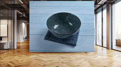 traditional luxury utensil dine ware Japanese ceramic china blue art drawing sakura flower design round big small gloss plate bowl w cloth and chopstick on blue wood table background Wall mural