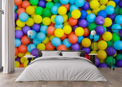 A colorful sea of bouncy balls in the kids' playground. A collection of brightly colored balls pit, mostly in shades of blue, yellow, red, and purple, fill the frame. Wall mural