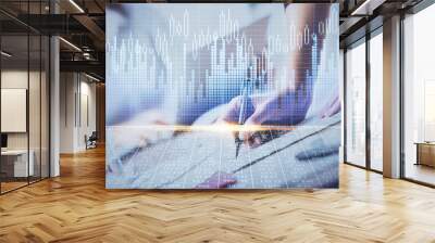 A woman hands writing information about stock market in notepad. Forex chart holograms in front. Concept of research. Double exposure Wall mural