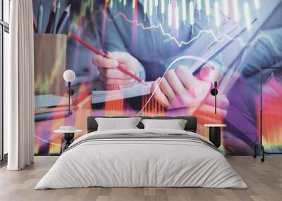 A woman hands writing information about stock market in notepad. Forex chart holograms in front. Concept of research. Multi exposure Wall mural