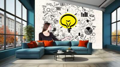 businesswoman holding lightbulb Wall mural