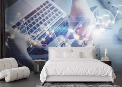 Double exposure of businesswoman hands typing on computer and financial graph hologram drawing. Stock market analysis concept. Wall mural