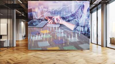 Double exposure of businesswoman hands typing on computer and forex graph hologram drawing. Financial analysis concept. Wall mural