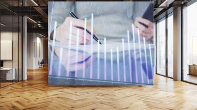 Double exposure of forex chart sketch hologram and woman holding and using a mobile device. Financial market concept. Wall mural