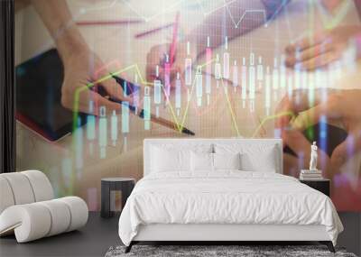 Double exposure of forex graph drawing and man and woman working together holding and using a mobile device. Trade concept. Wall mural