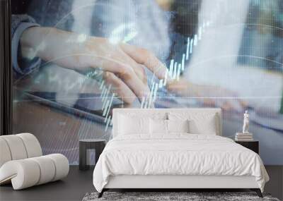 Double exposure of forex graph drawing and man and woman working together holding and using a mobile device. Trade concept. Wall mural