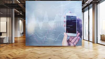 Double exposure of forex graph sketch hologram and woman holding and using a mobile device. Stock market concept. Wall mural