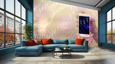 Double exposure of forex graph sketch hologram and woman holding and using a mobile device. Stock market concept. Wall mural