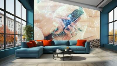 Double exposure of man's hand holding and using a digital device and brain hologram drawing. Data concept. Wall mural