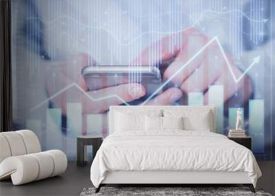 Double exposure of man's hands holding and using a digital device and forex graph drawing. Financial market concept. Wall mural