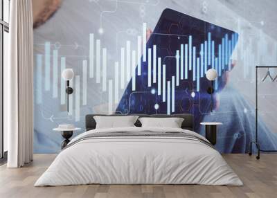 Double exposure of man's hands holding and using a digital device and forex graph drawing. Financial market concept. Wall mural