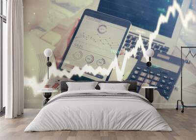 Double exposure of man's hands holding and using a digital device and forex graph drawing. Financial market concept. Wall mural