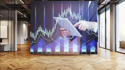 Double exposure of man's hands holding and using a digital device and forex graph drawing. Financial market concept. Wall mural