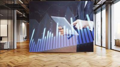 Double exposure of man's hands holding and using a digital device and forex graph drawing. Financial market concept. Wall mural