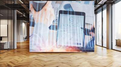 Double exposure of man's hands holding and using a phone and financial chart drawing. Market analysis concept. Wall mural