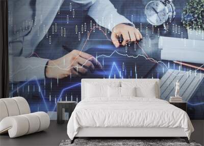 Double exposure of man's hands holding and using a phone and financial graph drawing. Analysis concept. Wall mural