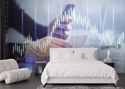 Double exposure of man's hands holding and using a phone and financial graph drawing. Analysis concept. Wall mural