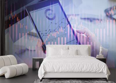 Double exposure of man's hands holding and using a phone and financial graph drawing. Analysis concept. Wall mural