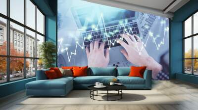 Double exposure of man's hands typing over laptop keyboard and forex chart hologram drawing. Top view. Financial markets concept. Wall mural