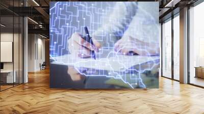 Double exposure of woman's writing hand on background with brain hud. Concept of learning. Wall mural