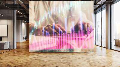 Double exposure of woman hands typing on computer and forex chart hologram drawing. Stock market invest concept. Wall mural