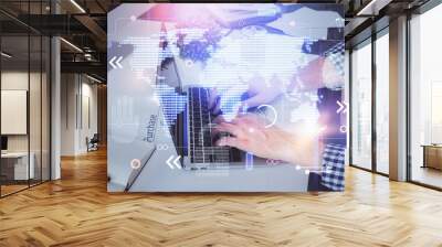 Double exposure of world map hologram with man working on computer on background. Concept of worldwideweb. Wall mural