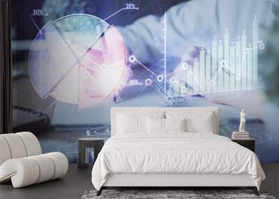 Financial forex graph displayed on hands taking notes background. Concept of research. Double exposure Wall mural