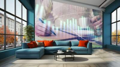 Forex chart hologram on hand taking notes background. Concept of analysis. Double exposure Wall mural