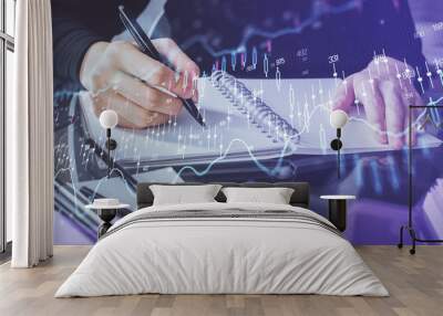 Forex chart hologram on hand taking notes background. Concept of analysis. Multi exposure Wall mural