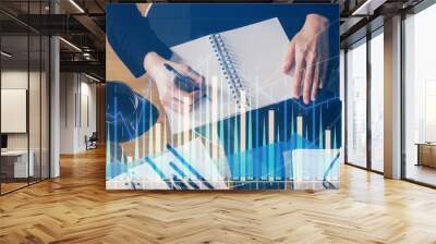 Forex graph on hand taking notes background. Concept of research. Multi exposure Wall mural