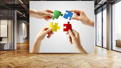 hands and puzzle on gray background. teamwork solving a puzzle Wall mural