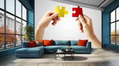 hands with puzzle. teamwork solving a puzzle Wall mural