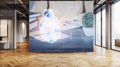 Heart hologram over woman's hands writing background. Concept of Medical study. Multi exposure Wall mural