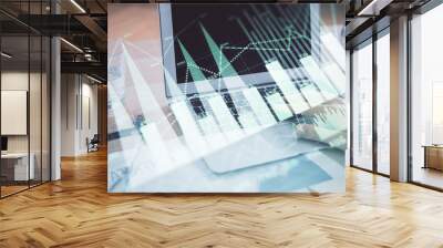 Multi exposure of market chart with man working on computer on background. Concept of financial analysis. Wall mural