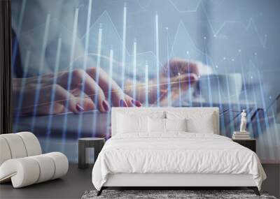 Multi exposure of woman hands typing on computer and financial graph hologram drawing. Stock market analysis concept. Wall mural