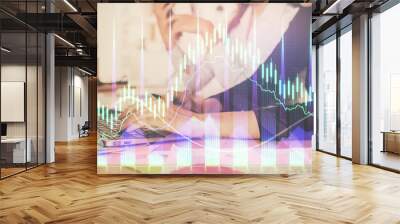 Multi exposure of woman hands typing on computer and financial graph hologram drawing. Stock market analysis concept. Wall mural