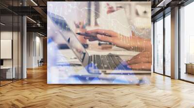 Multi exposure of woman hands typing on computer and financial graph hologram drawing. Stock market analysis concept. Wall mural