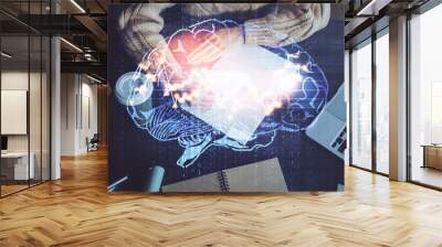 Multi exposure of writing hand on background with brain hologram. Concept of learning. Wall mural