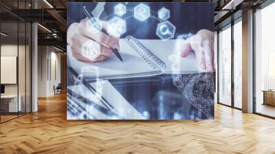 Tech theme hologram over woman's hands taking notes background. Concept of hightech. Double exposure Wall mural