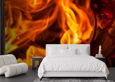 Full frame close-up of roaring yellow campfire with sticks and twigs catching fire Wall mural