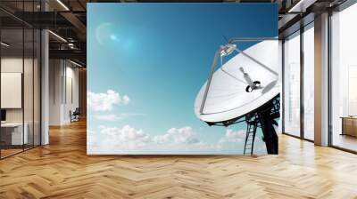 Big parabolic antenna with lens flare sun against sky Wall mural