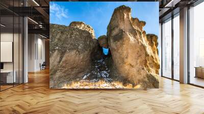 Natural rock formation consisting of big boulder stuck between two rocks in the Rhodope mountain in Bulgaria (called in Bulgarian Karadjov Kamak) Wall mural