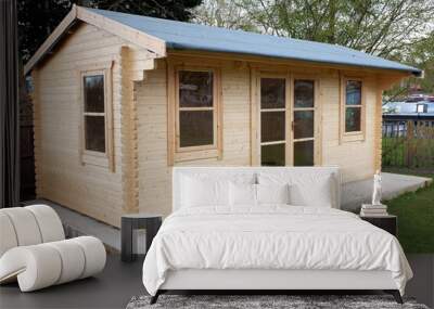 Pine wood log cabin or wooden summer house on concrete base with waterproof felt roof Wall mural